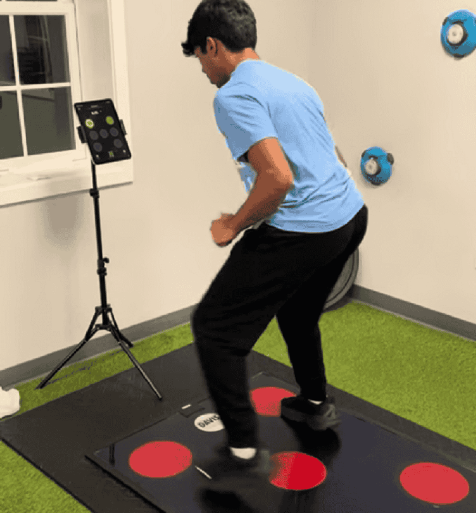 Athlete using QuickBoard reaction training to improve timing and footwork before softball playoffs